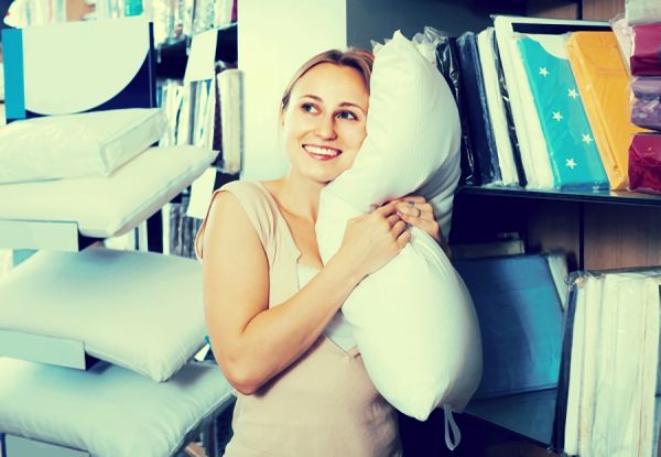 低めの枕を抱きしめる女性の画像
